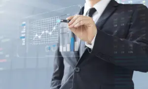 Biznesmen analizujący wykresy, analizując różne rodzaje akcji i ich dynamikę na giełdzie.
