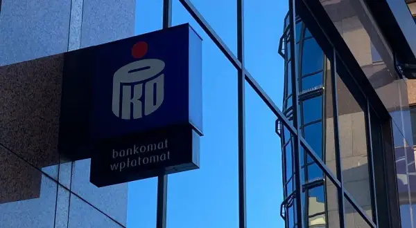 Logo PKO z napisem "bankomat wpłatomat" na tle szklanej fasady budynku. Idealne miejsce na szybkie przelewy przychodzące PKO.