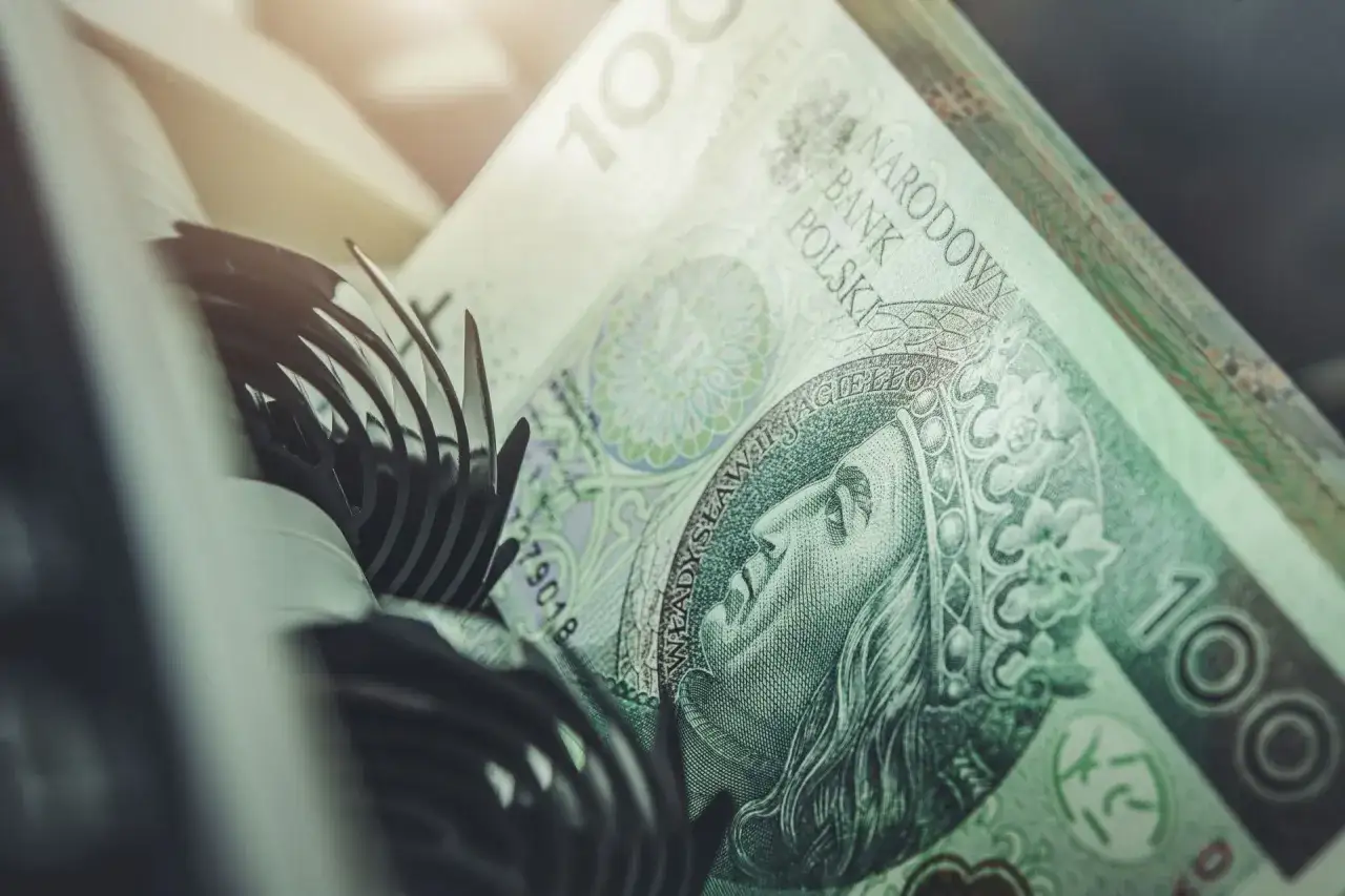 Stos banknotów 100 zł, z widocznym portretem króla. Wartość nominalna obligacji jest tu symbolizowana przez te pieniądze.